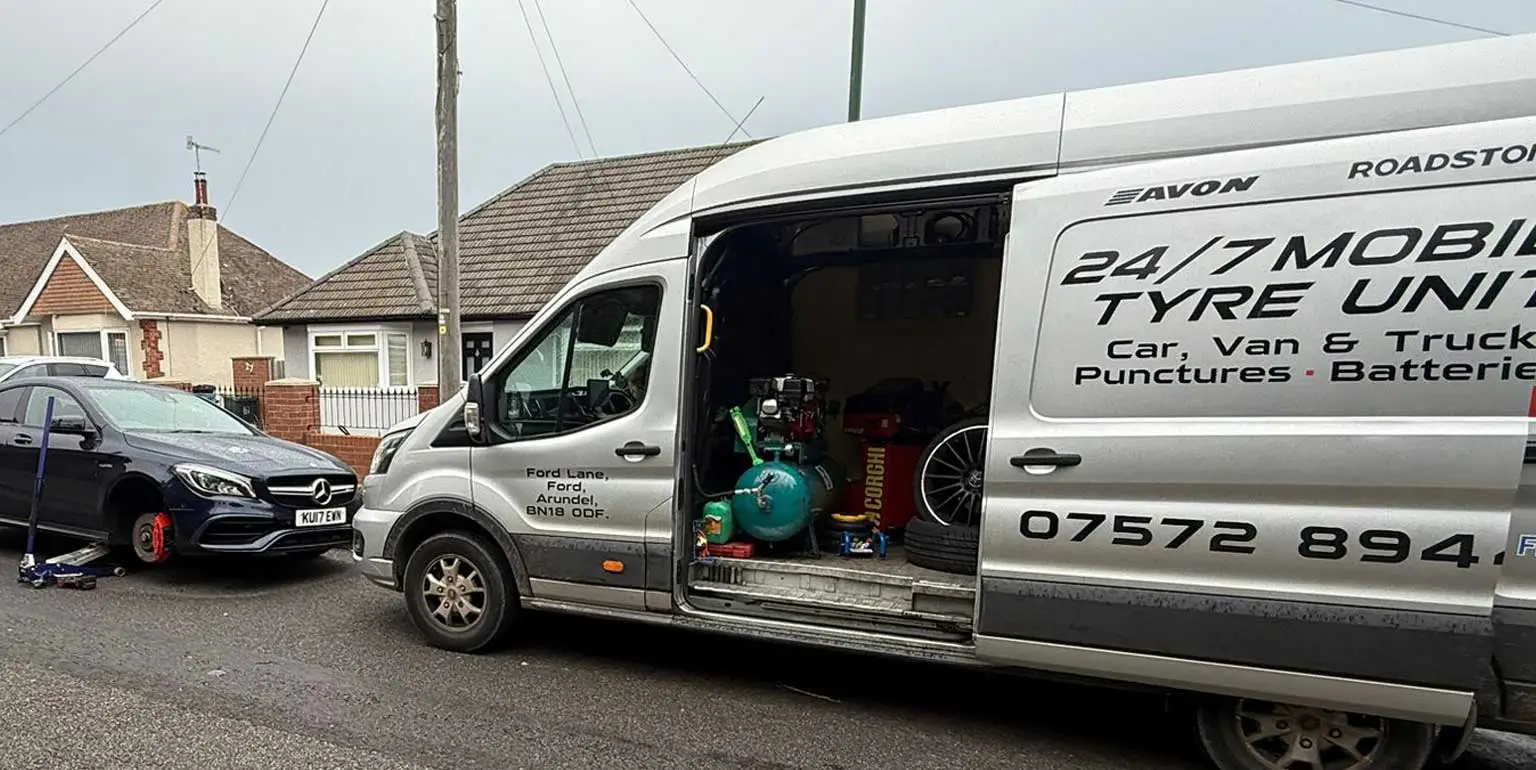 Emergency mobile tyre fitting Angmering by Ford Lane Tyres - tyre van parked up fixing a tyre on a mercedes car