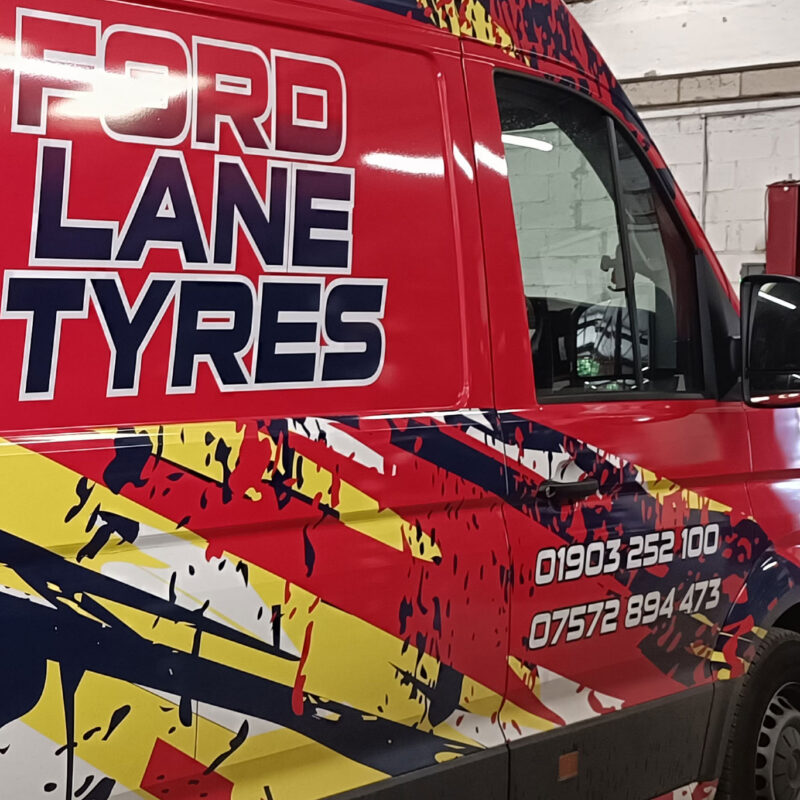 image of the new Ford Lane Tyres Mobile Van with bright red and yellow graphics and phone numbers